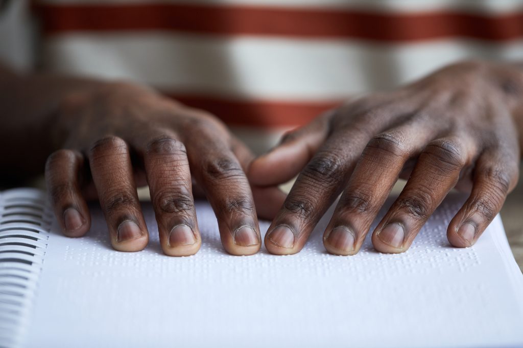 Man reading braille