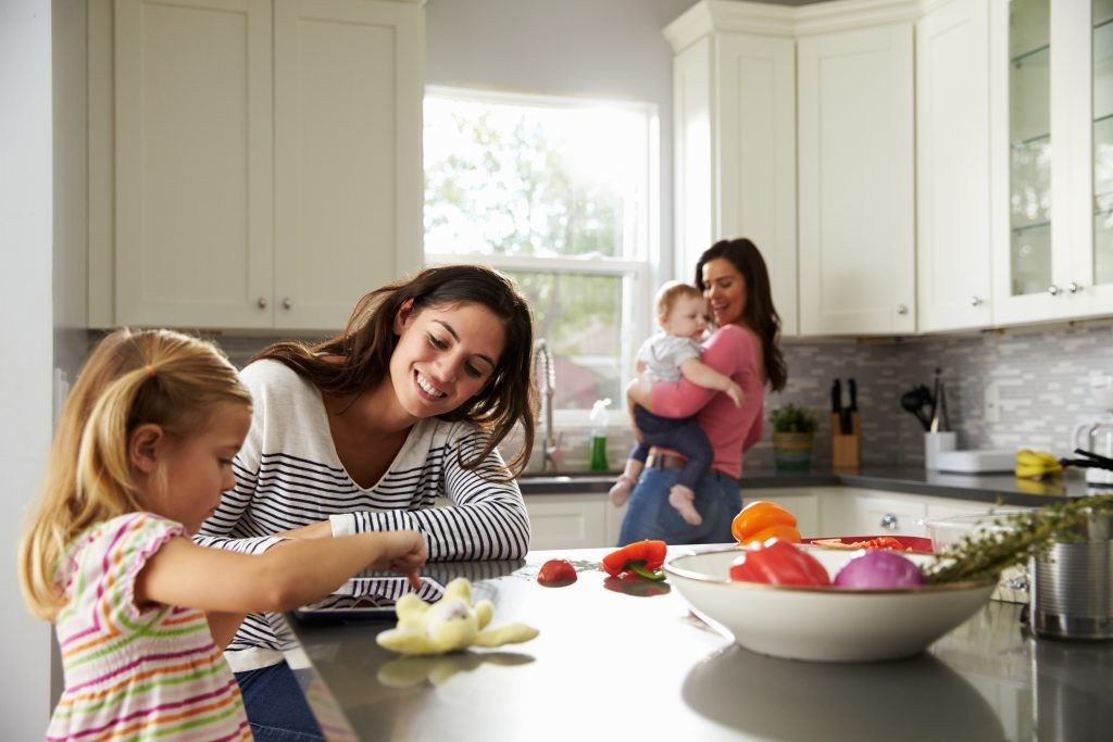 Couple in the kitchen with their two children