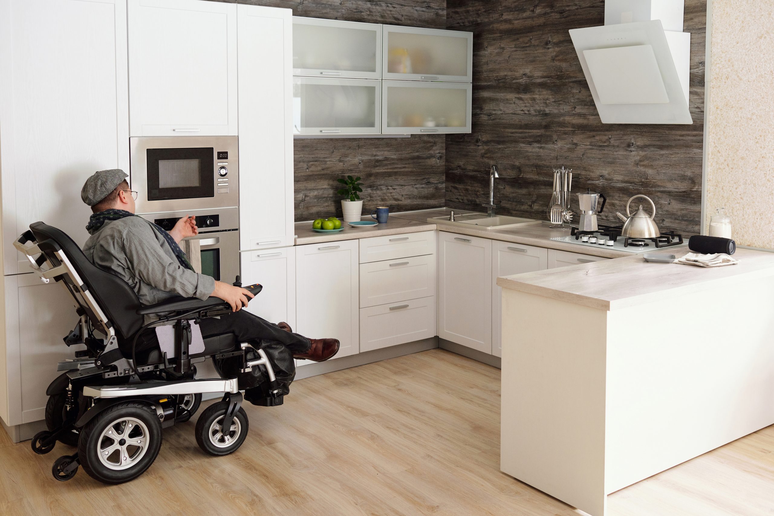 Man in a wheelchair using a cooker